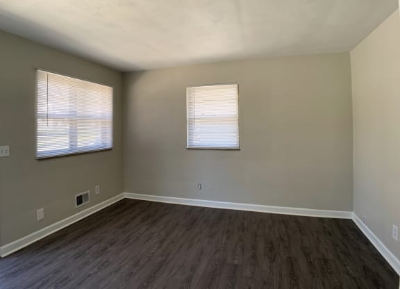 Spacious living room with vinyl flooring  and 2 windows