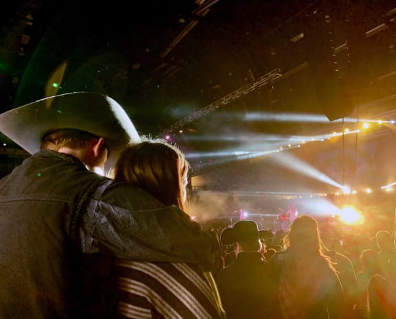 a couple watching a concert in a crowd