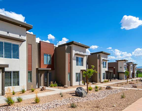 A row of modern houses with brown and beige exteriors.