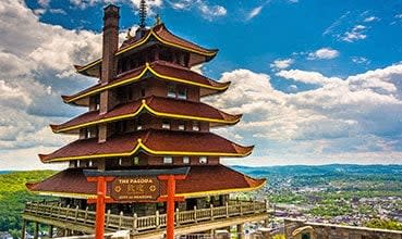a pagoda on top of a tower overlooking a city