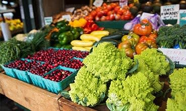 a bunch of different fruits and vegetables on a table