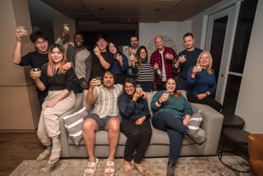 a group of people sitting on a couch holding wine glasses at Southpark on Whyte, Edmonton
