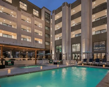 a large swimming pool in front of a building