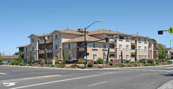 Apartment building with a crosswalk in front of it.