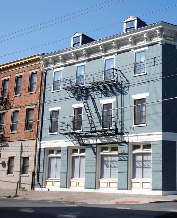 a building on the corner of a street with cars parked in front of it