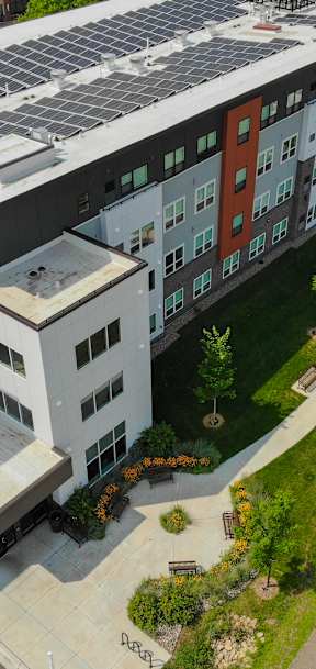 A modern building with a green roof and solar panels.