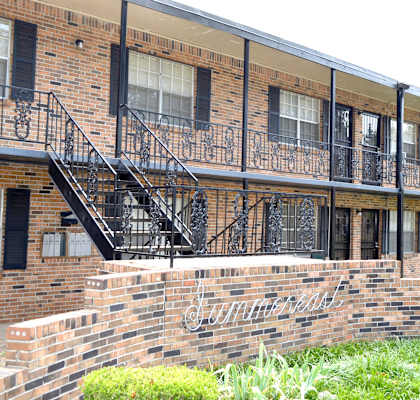 a brick building with black metal railings