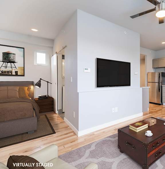 A modern living room with a flat screen TV mounted on the wall.