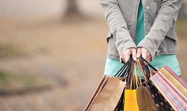 a woman holding bags and shopping bags