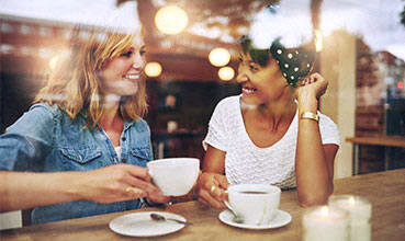 a group of people sitting around a table drinking wine