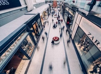 an aerial view of a shopping mall with people walking around