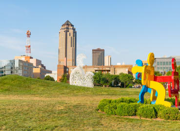 two sculptures in a park with a city in the background at The Equitable Building, Des Moines, IA, 50309