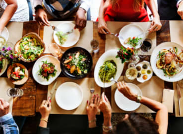 a group of people sitting around a table eating food at The Equitable Building, Des Moines, IA, 50309