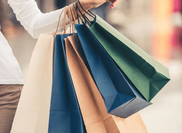 a woman holding a bunch of shopping bags