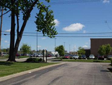 A parking lot with cars and trees.
