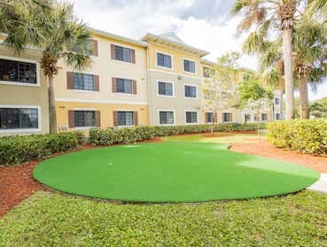 large putting green and neat landscaping