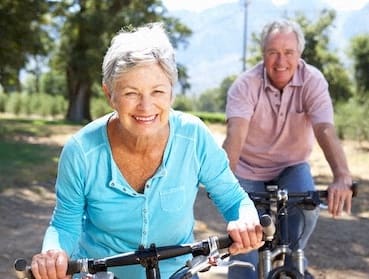 happy senior couple riding bikes and enjoying life