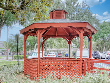 gazebo surrounded by lush trees and landscaping at Orlando Cloisters senior apartments