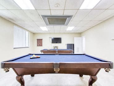 Pool tables and TV in resident lounge at Morris Manor Apartments