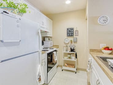 Kitchen with appliances, sink, and decor
