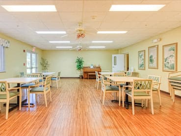 Community room with tables and chairs and piano