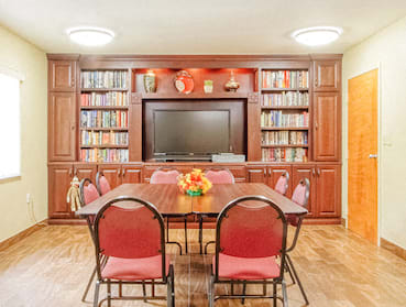 library with shelves of books and a reading table with chairs