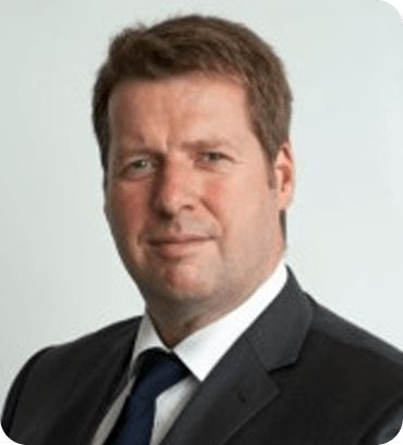 a man in a suit and tie looking at the camera