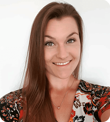 a woman with long brown hair smiling at the camera