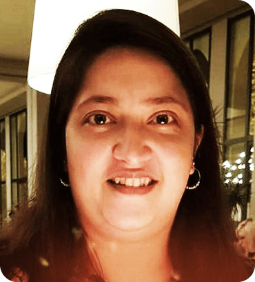 a woman with long hair is smiling at the camera