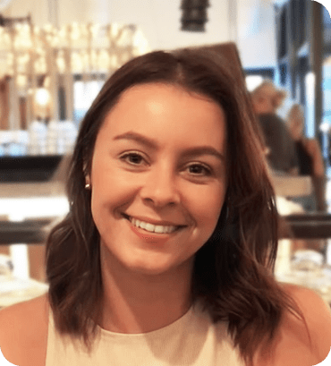 a woman with long brown hair smiles at the camera