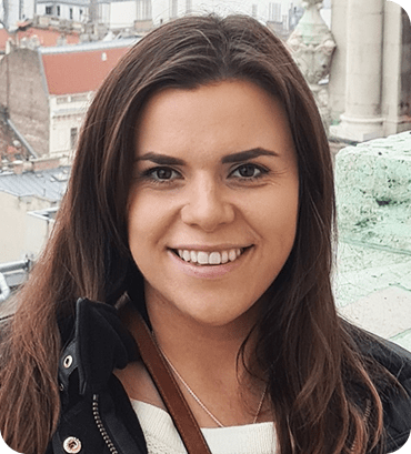 a woman with long brown hair smiles at the camera