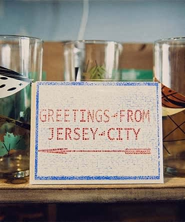 a sign that says greetings from jerky city on a table at The Enclave, Jersey City, New Jersey