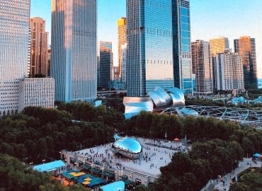 an aerial view of a city with skyscrapers and a park