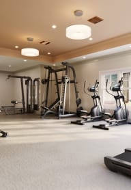 a workout room with exercise equipment in a home gym