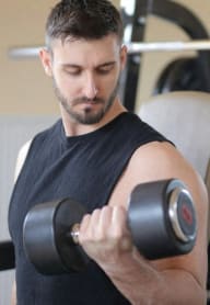 a man working out with dumbbells in a fitness center