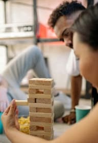 a diverse group of people playing Jenga together