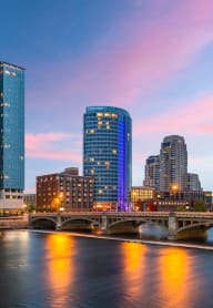 Grand Rapids, Michigan skyline with a bridge and a river at dusk