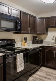a kitchen with black appliances and granite countertops