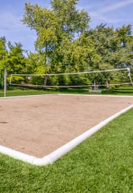 a volleyball court at the whispering winds apartments in pearland, tx