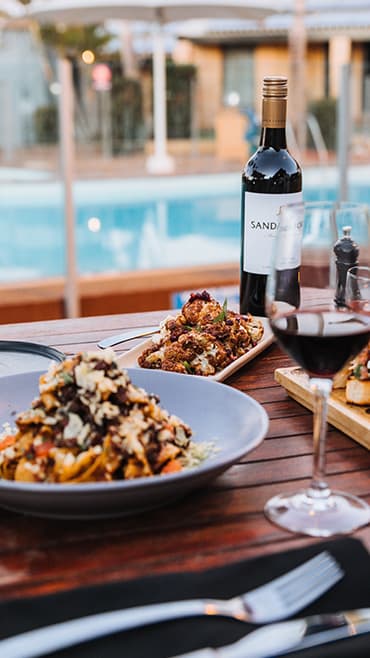 Lifestyle photo of food and drinks near the pool at Marbrisa Apartments, Miami Gardens