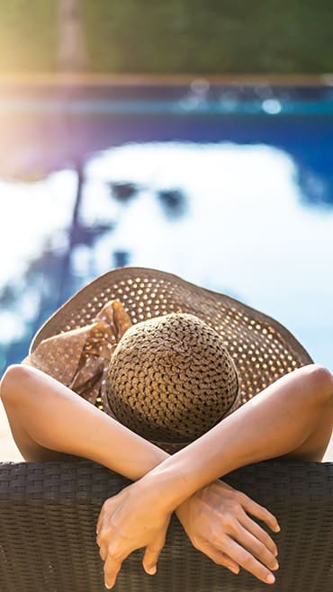 Woman lounging by the pool at Alhambra Cove, Florida, 33167