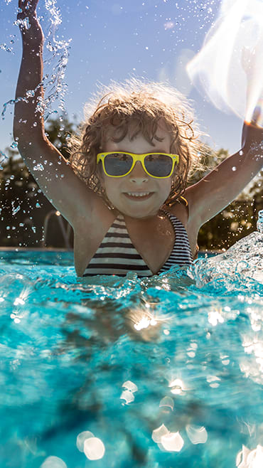 Lifestyle photo of jumping in the pool at Mirabella Apartments, Princeton, FL