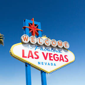 Sign saying "Welcome to Fabulous Las Vegas Nevada" next to palm trees.
