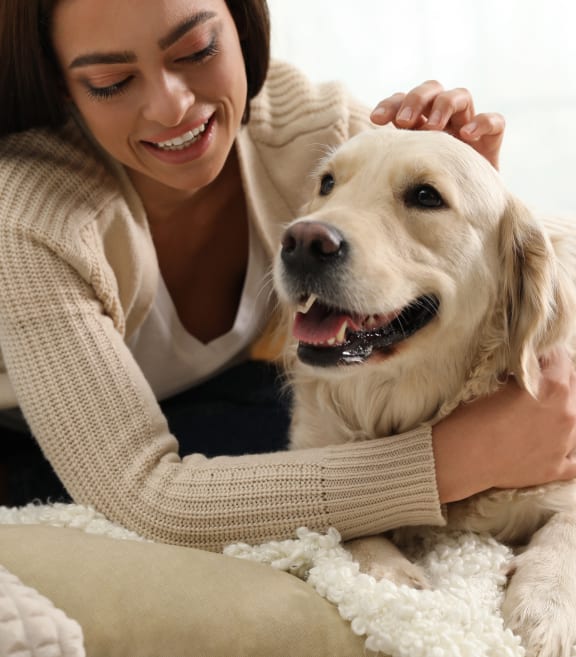 a woman laying on the floor with a dog
