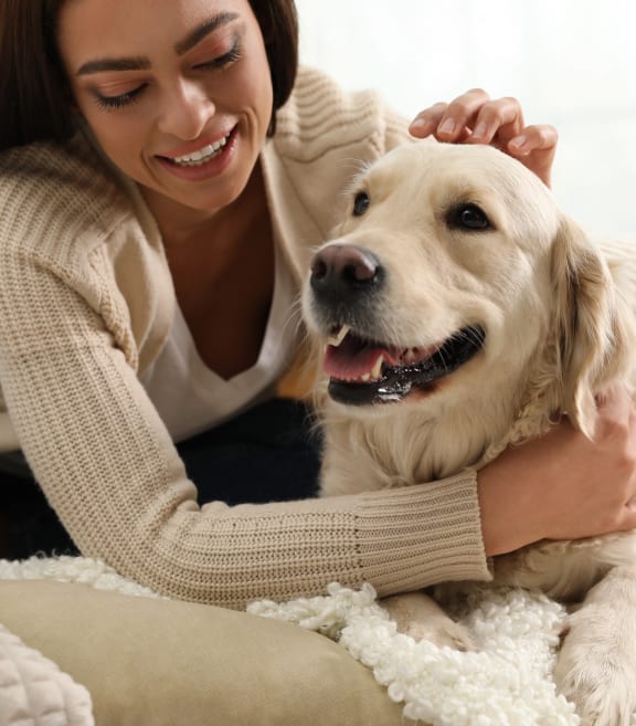 a woman laying on the floor with a dog