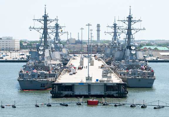 a group of ships are docked in a harbor at Gates of West Bay, Norfolk