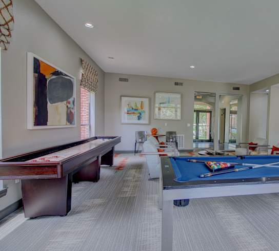 a games room with a pool table and ping pong table