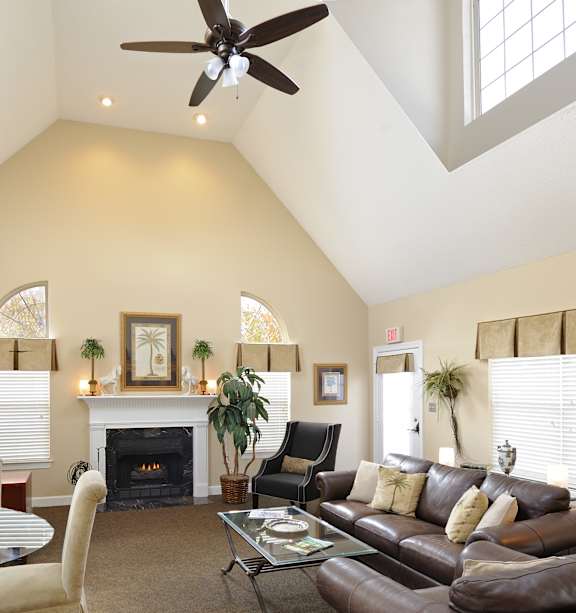 A living room with a fireplace and a ceiling fan.at Summerland Heights, Woodbridge, VA