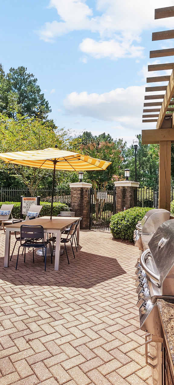 A house with a lit fireplace on the patio.