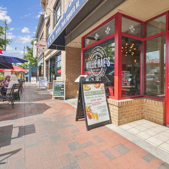 A sign for Willey's sits in front of a red building.